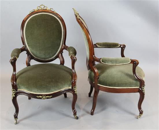 A pair of Victorian rosewood armchairs, W.2ft 1in. D.2ft 4in. H.3ft 4in.